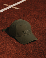 Green cap with 'Sena' logo on a red track surface