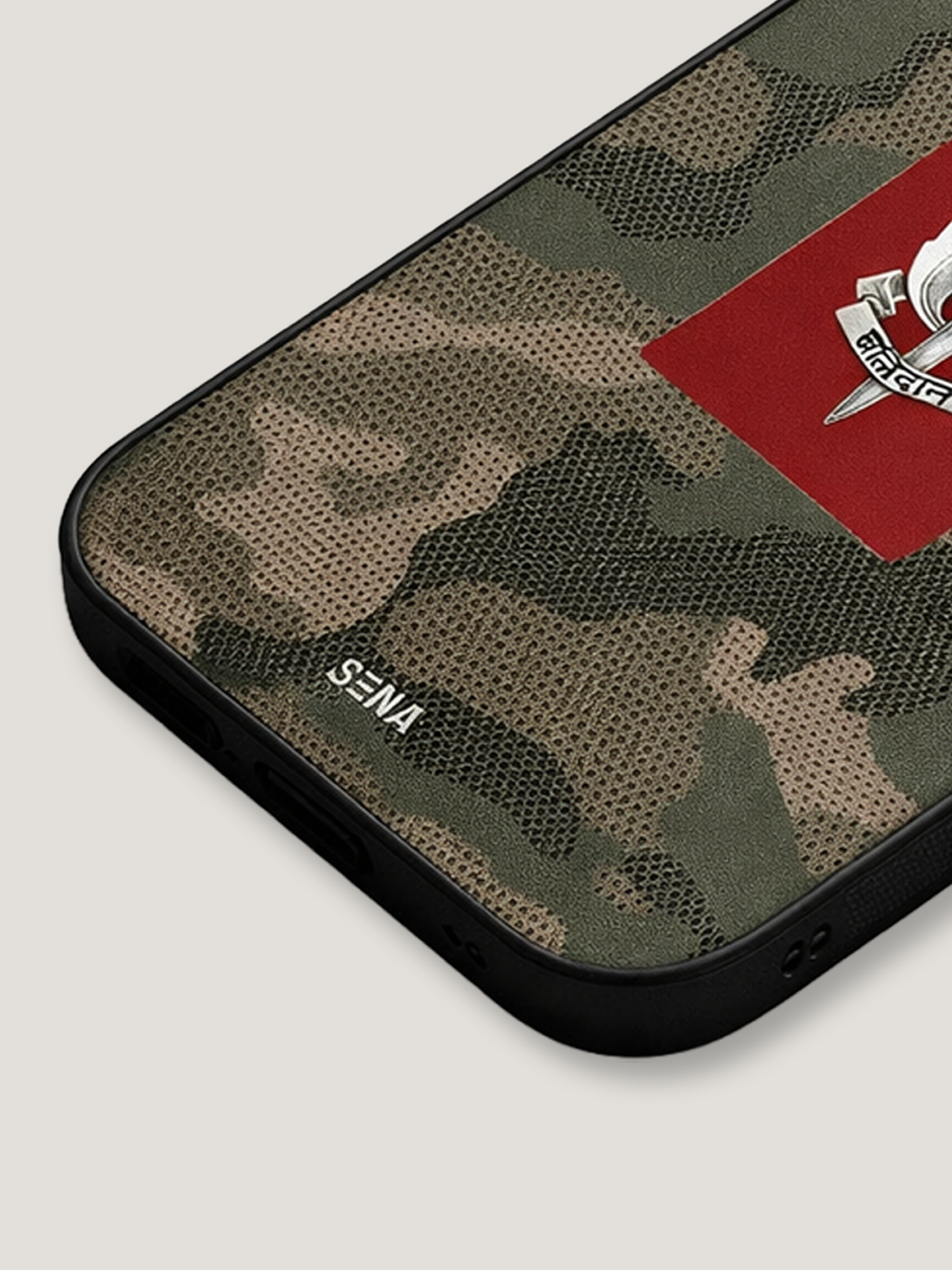 Camouflage phone case with a red patch and 'Sena' branding on a light gray background
