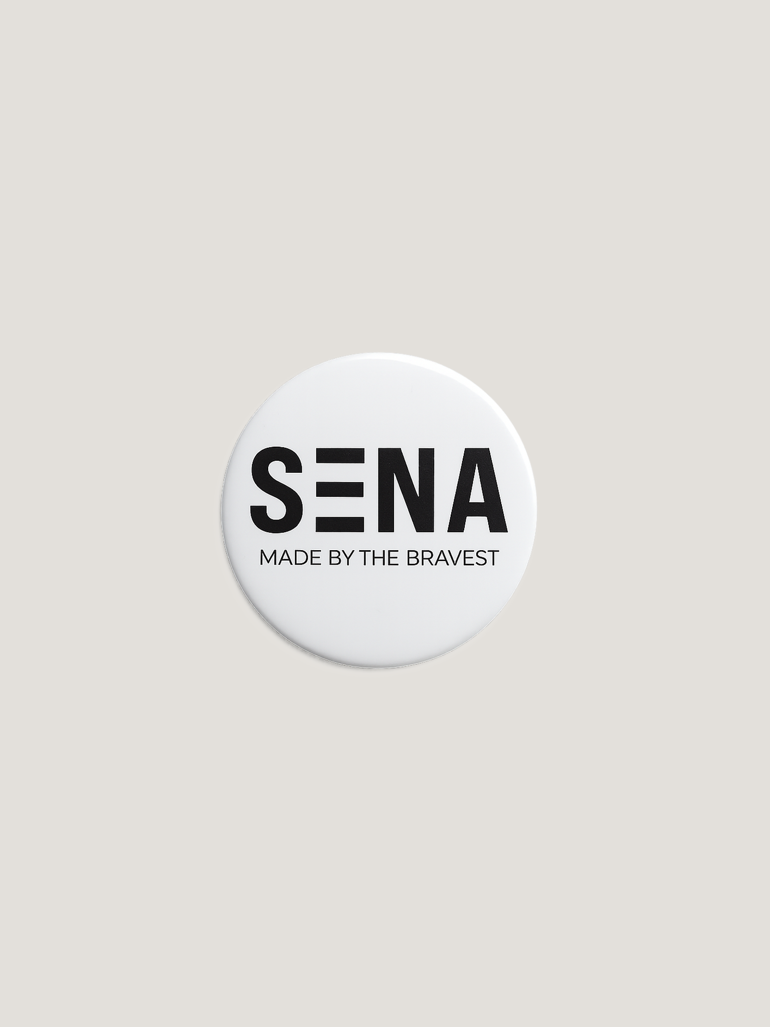 Round white badge with 'SENA Made by the Bravest' text on a beige background