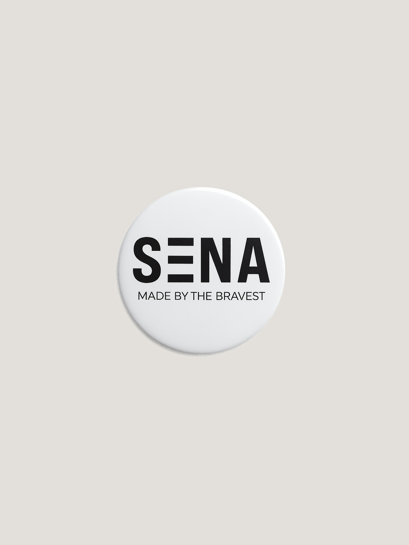 Round white badge with 'SENA Made by the Bravest' text on a beige background